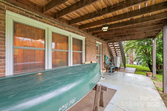 a view of a backyard with sitting area and large windows