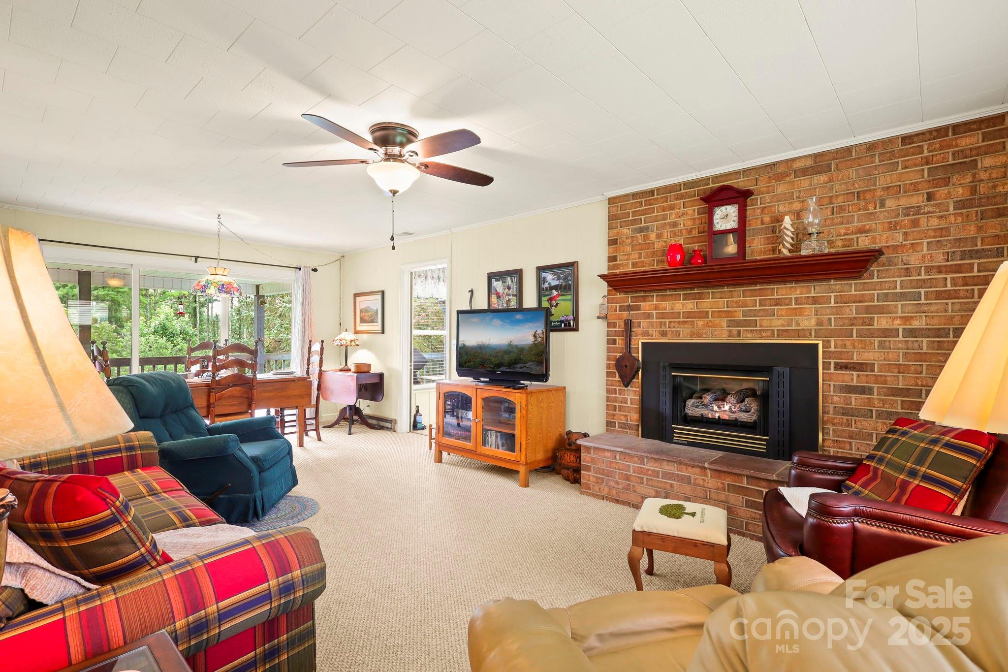 1074 Nikanor Road West Jefferson, NC 28694 - Photo 5 of 45 a living room with furniture and a fireplace