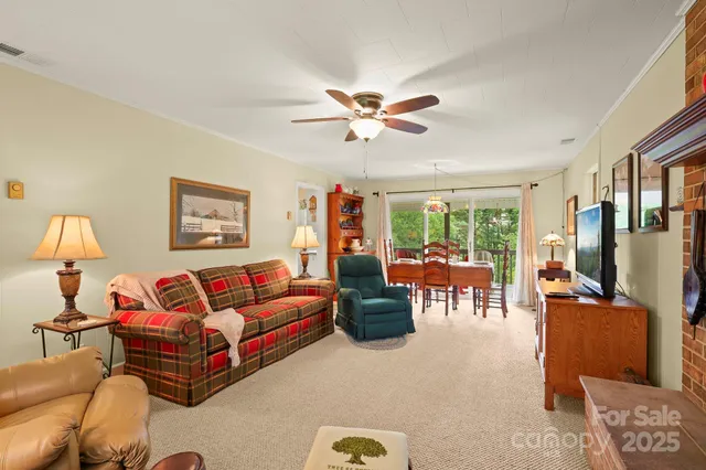 a living room with furniture ceiling fan and a window