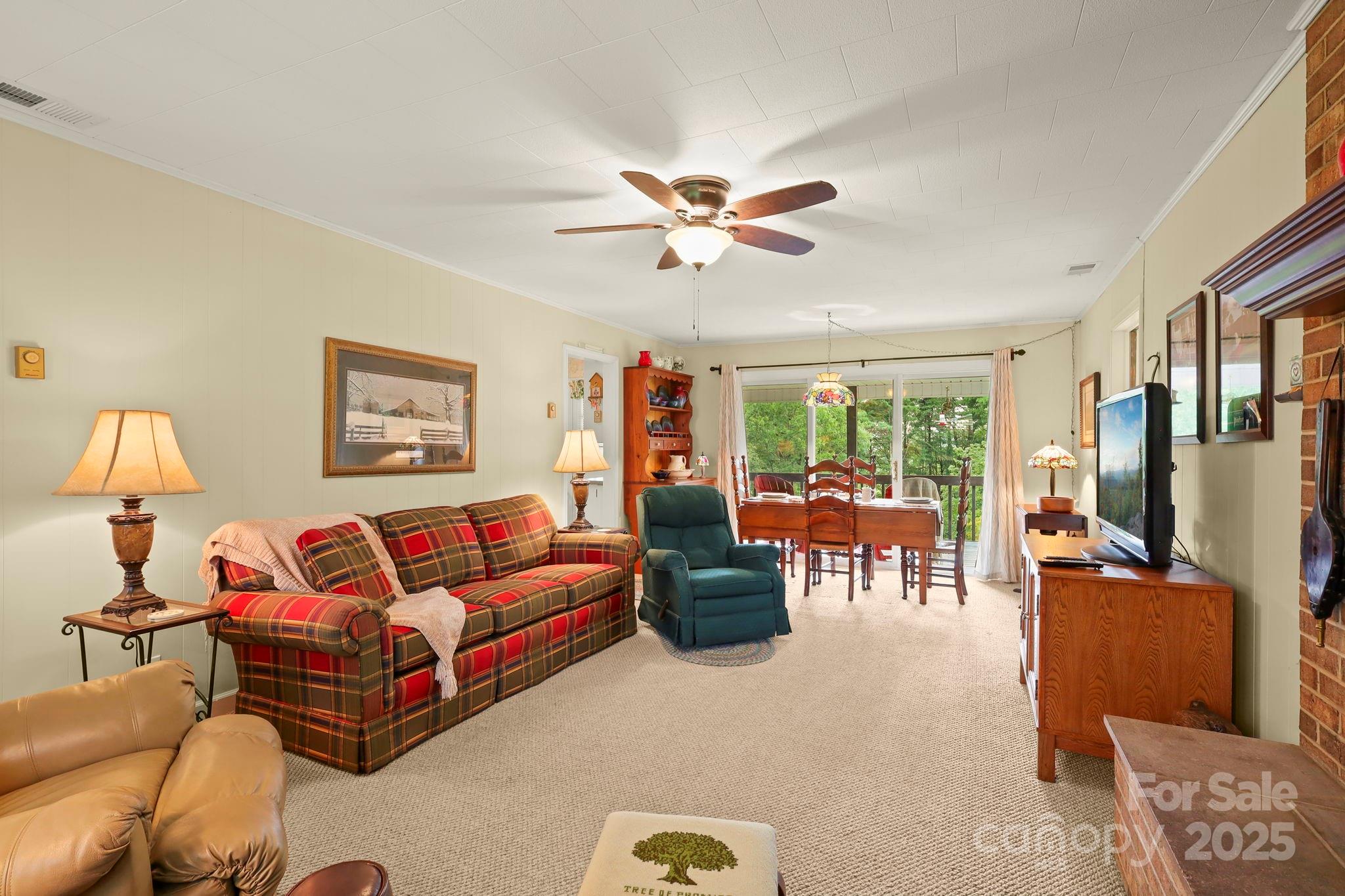 1074 Nikanor Road West Jefferson, NC 28694 - Photo 9 of 45 a living room with furniture ceiling fan and a window
