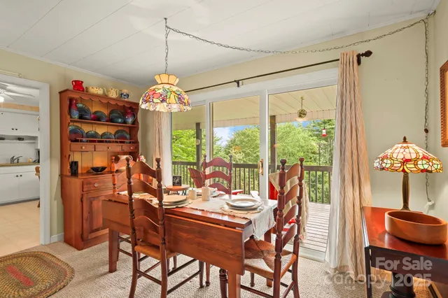 a dining room filled with furniture and potted plants