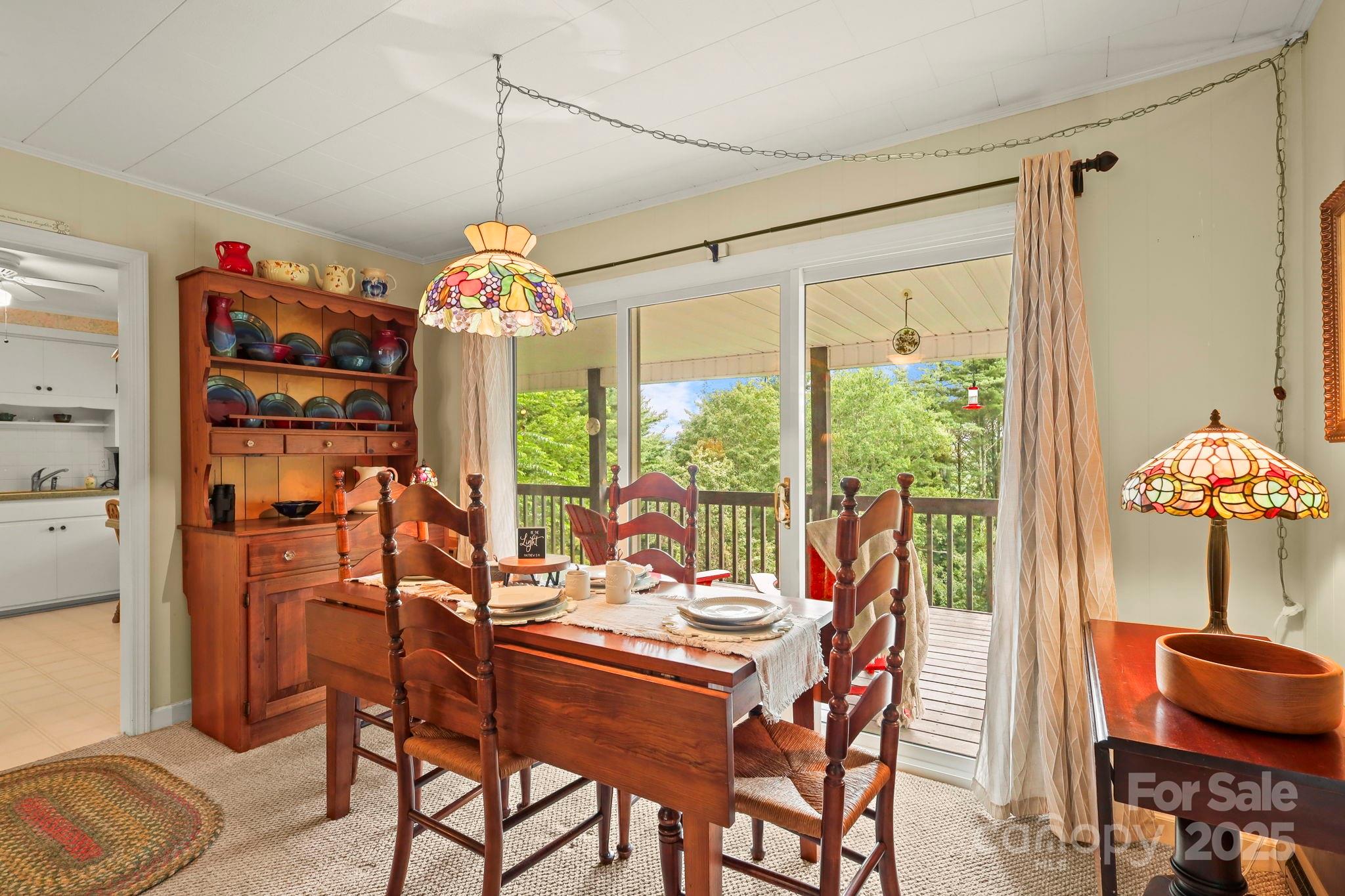1074 Nikanor Road West Jefferson, NC 28694 - Photo 10 of 45 a dining room filled with furniture and potted plants