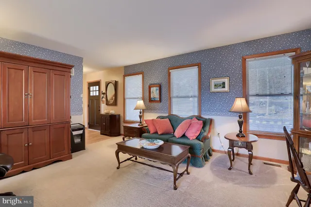 a living room with furniture and a lamp