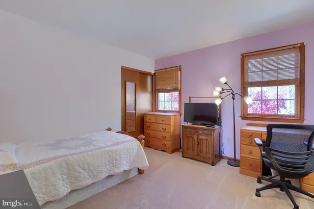 a bedroom with a bed and a chair in it