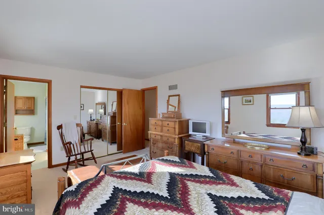 a room with furniture a rug and a lamp