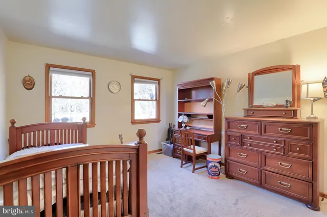 a bedroom with a bed and a dresser in it