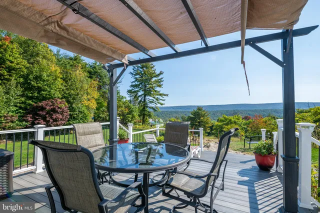 a view of an outdoor dining space with a table and chairs