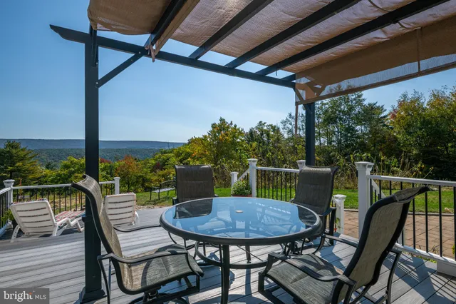 a view of a balcony with a table and chairs