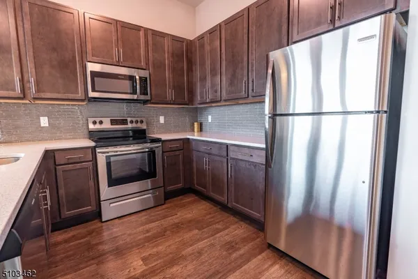a kitchen with wooden cabinets and white appliances