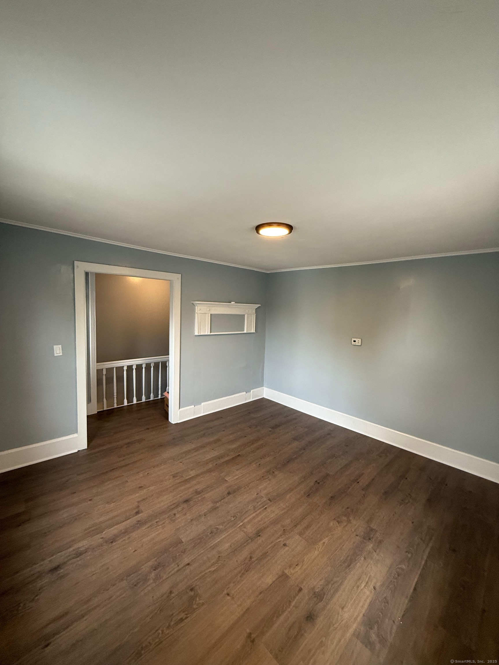 79 Spring Street, Unit 2 Middletown, CT 06457 - Photo 11 of 15 an empty room with wooden floor and windows