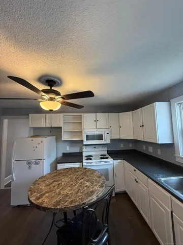 a kitchen with kitchen island cabinets counter space and appliances