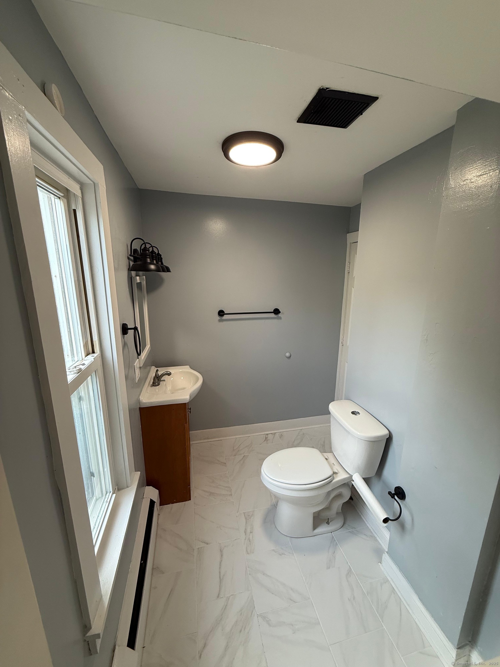79 Spring Street, Unit 2 Middletown, CT 06457 - Photo 5 of 15 a bathroom with a toilet sink and mirror