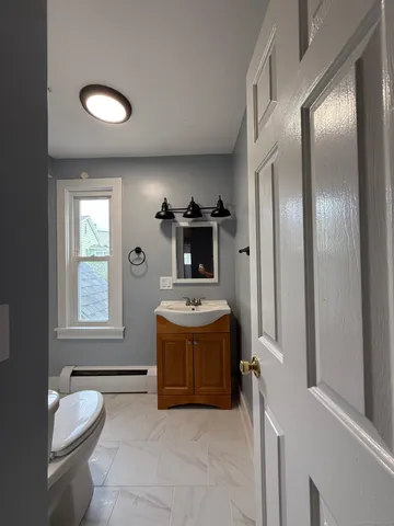 a bathroom with a tub sink mirror and shower