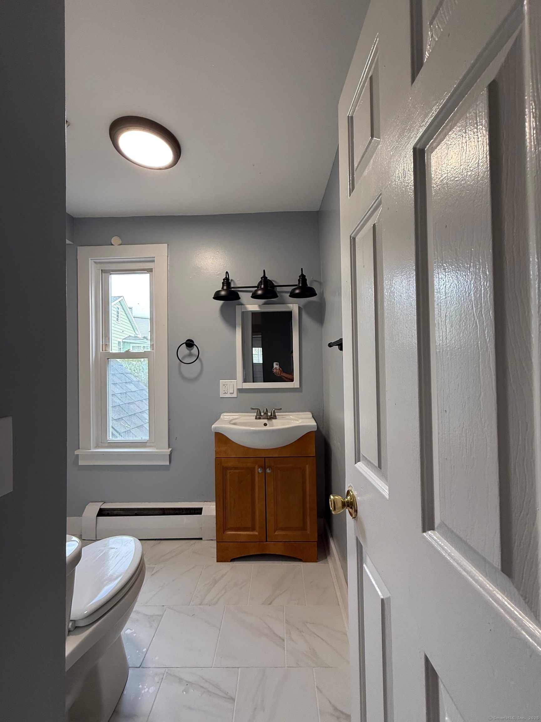 79 Spring Street, Unit 2 Middletown, CT 06457 - Photo 6 of 15 a bathroom with a tub sink mirror and shower