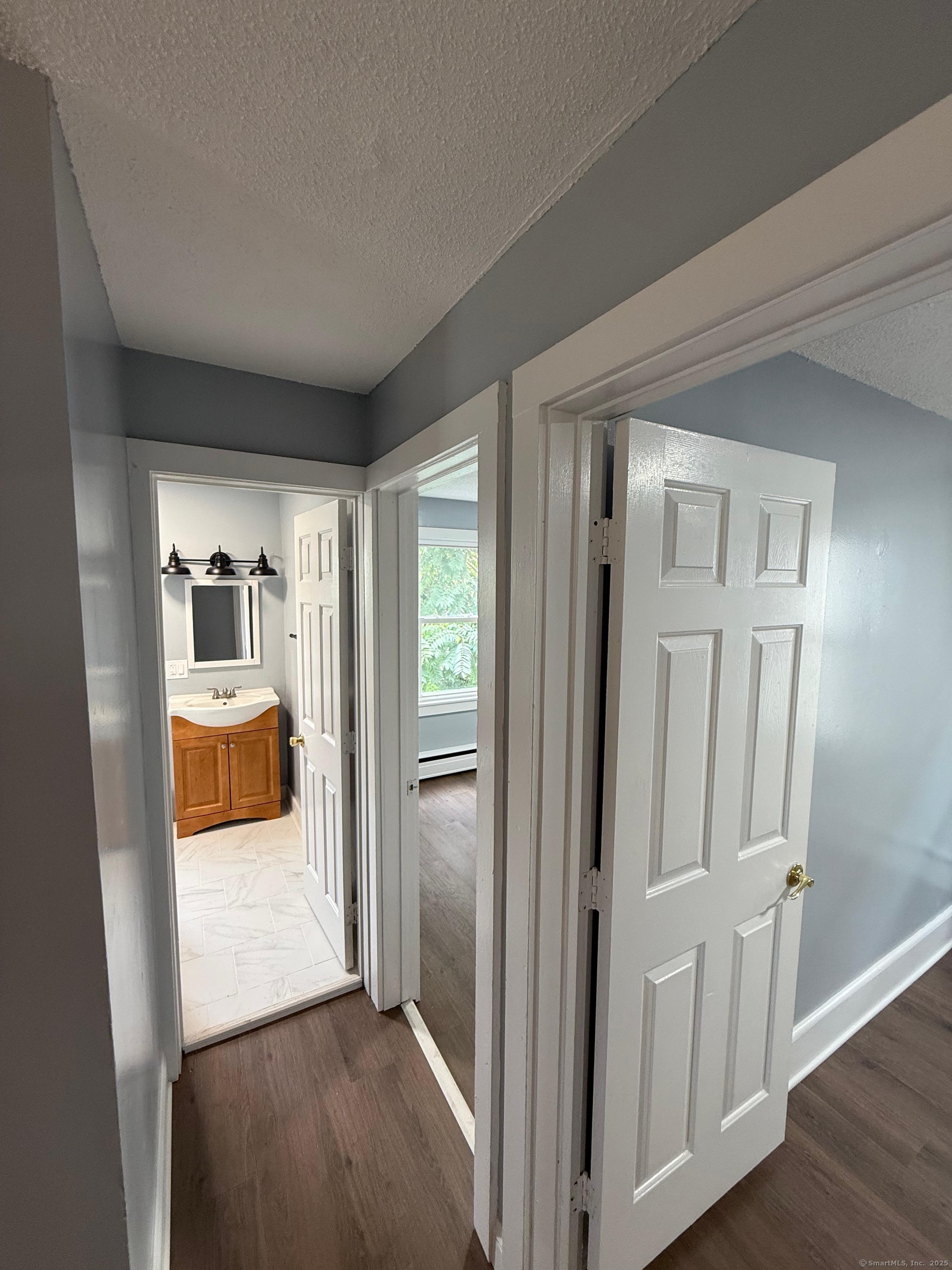 79 Spring Street, Unit 2 Middletown, CT 06457 - Photo 9 of 15 a view of a bedroom from the hallway