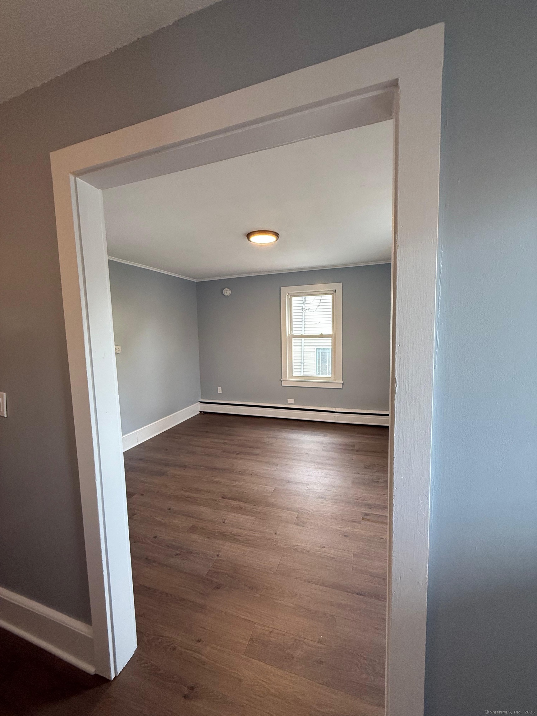79 Spring Street, Unit 2 Middletown, CT 06457 - Photo 10 of 15 a view of empty room with window and wooden floor