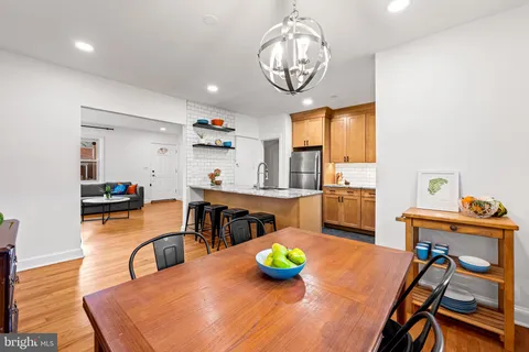 a dining room with furniture a window and wooden floor