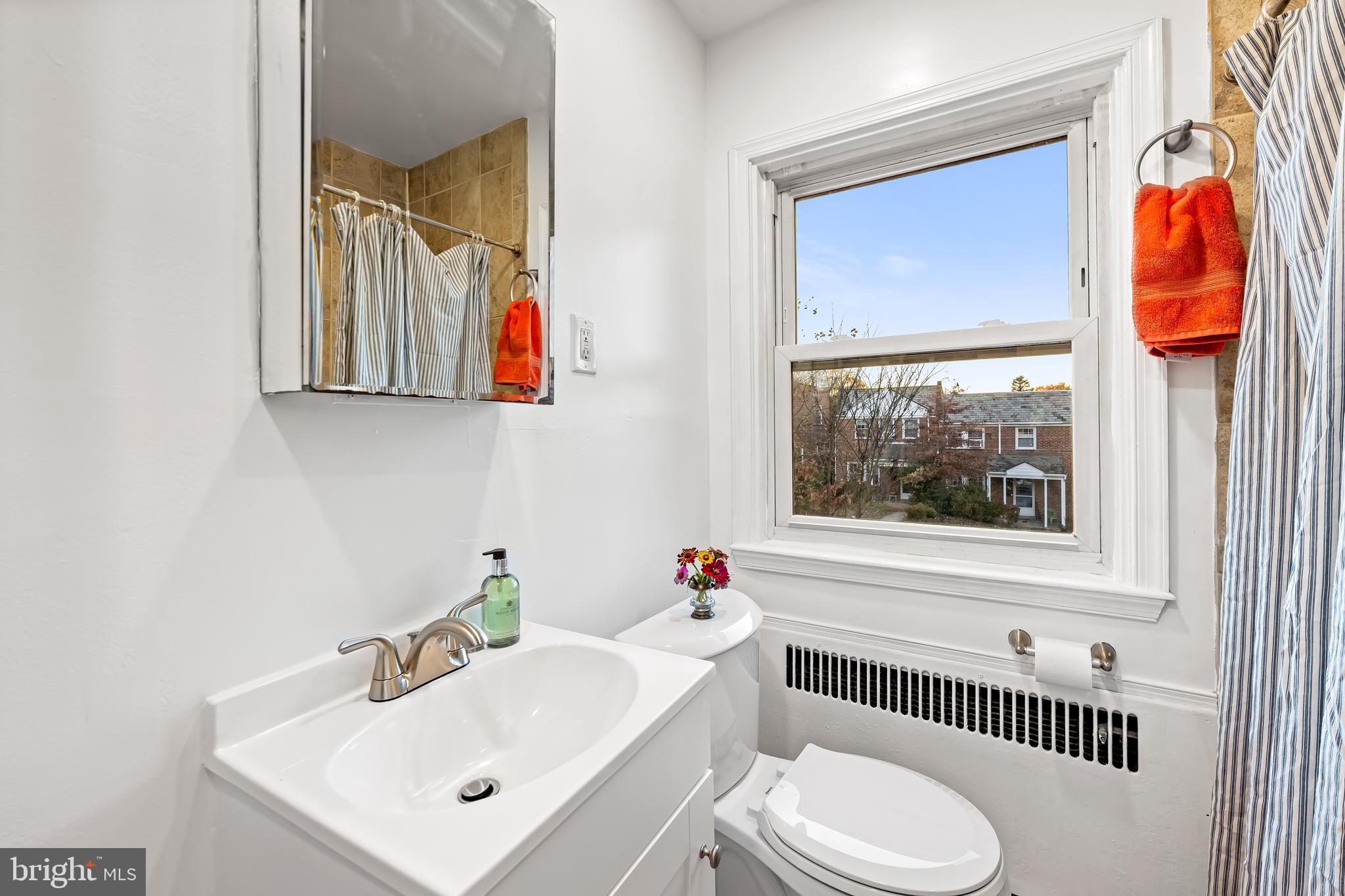 63 Burkshire Road Towson, MD 21286 - Photo 22 of 43 a bathroom with a toilet a sink and mirror
