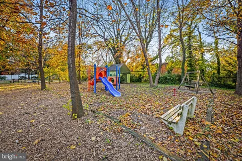 a view of outdoor space with playground and green space