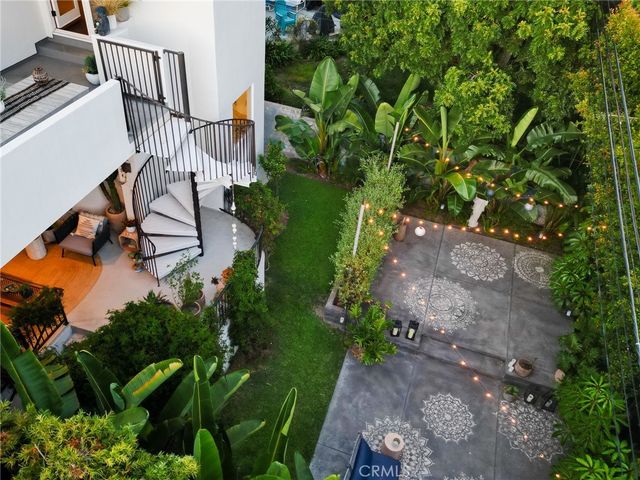 a bedroom with a bed lamp and a potted plant