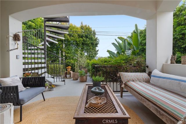 a bedroom with a bed and a refrigerator