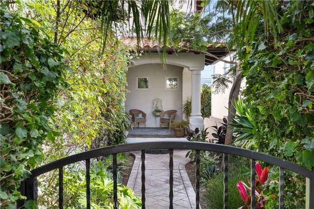 a bedroom with a bed couch and a window