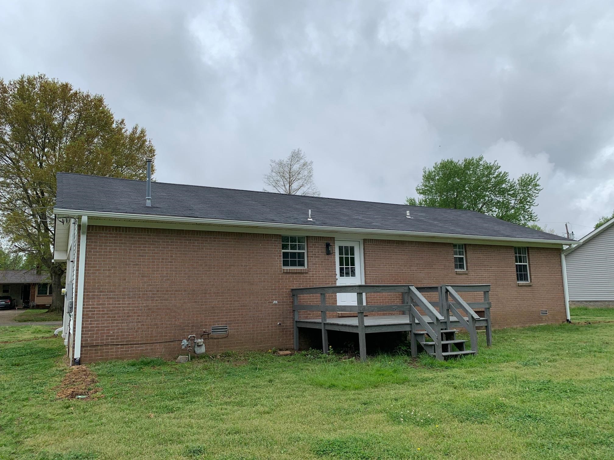 80 Halliburton Street Gates, TN 38037 - Photo 4 of 14 a backyard of a house with table and chairs