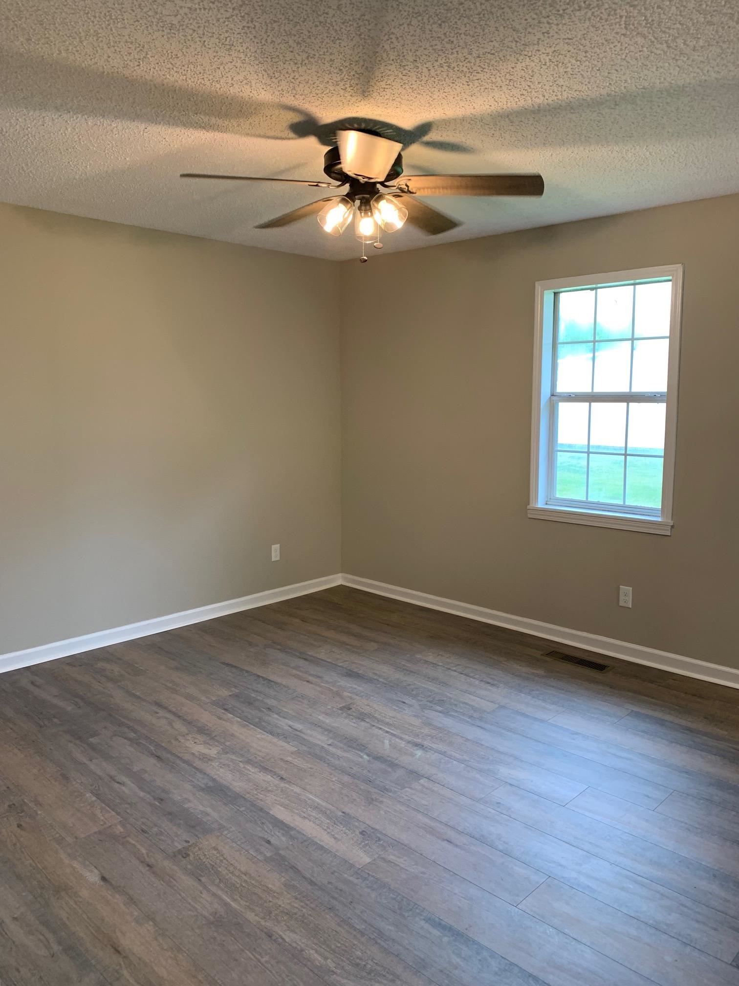 80 Halliburton Street Gates, TN 38037 - Photo 6 of 14 a view of an empty room with wooden floor and a window