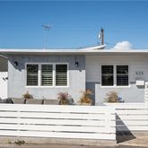a front view of a house with a potted plant