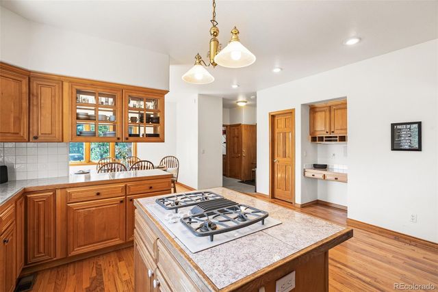 a kitchen with a stove and a refrigerator