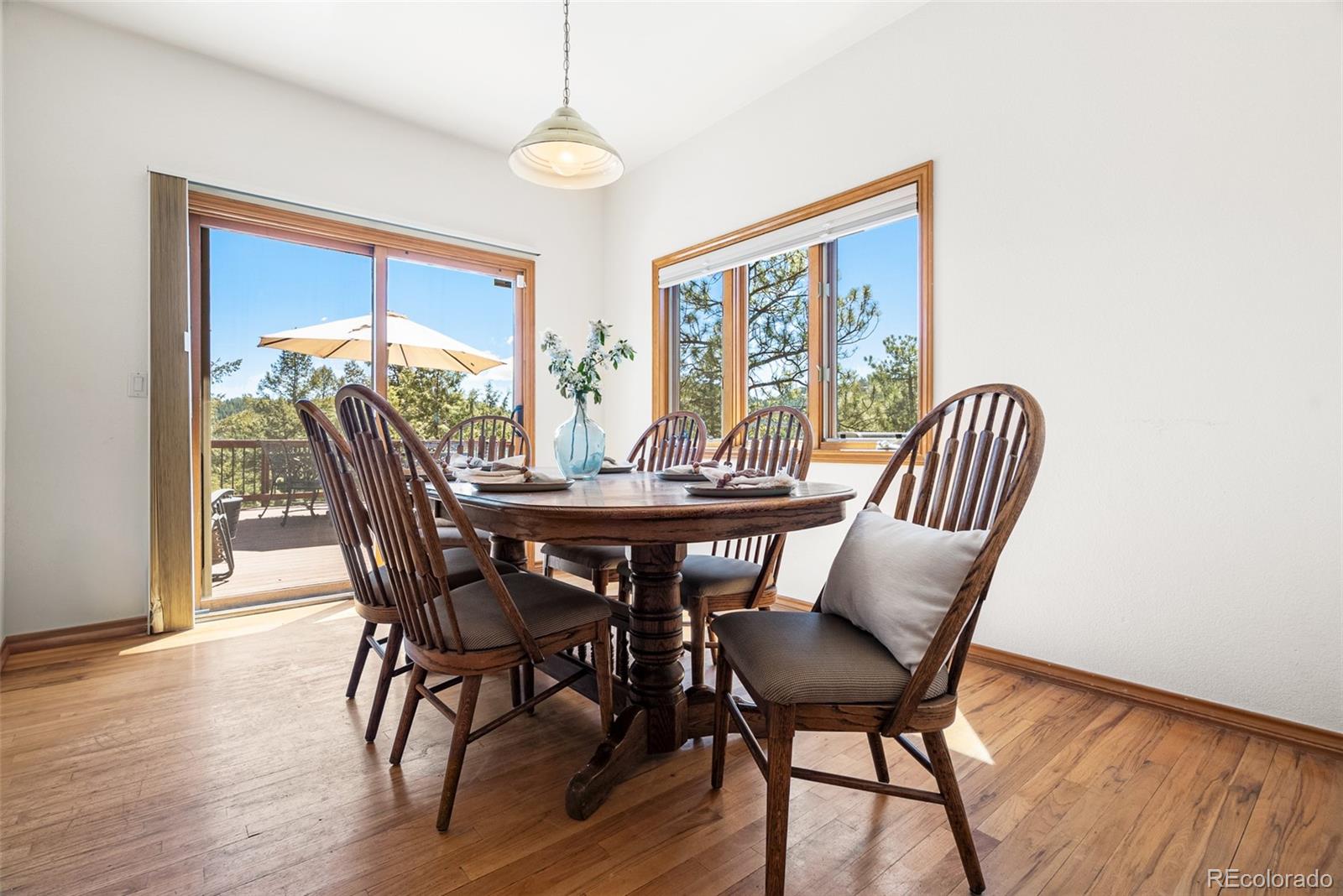 6252 King Drive Evergreen, CO 80439 - Photo 13 of 50 a view of a dining room with furniture window and wooden floor