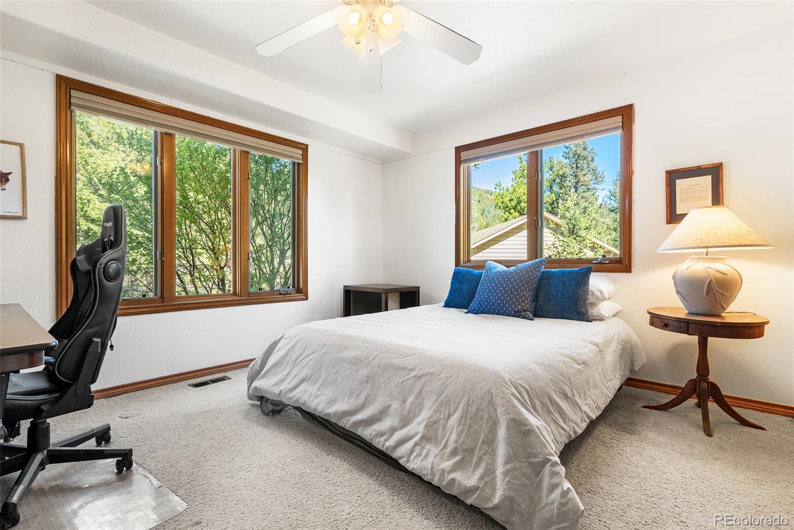 6252 King Drive Evergreen, CO 80439 - Photo 17 of 50 a bedroom with a bed window and chair