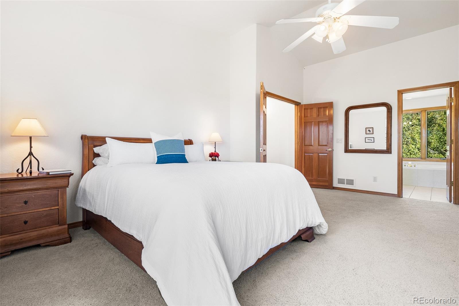 6252 King Drive Evergreen, CO 80439 - Photo 23 of 50 a bed room with a bed and a chandelier