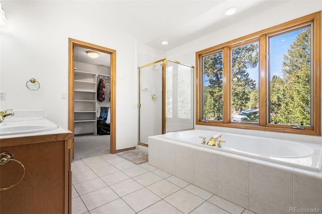 a spacious bathroom with a tub and a sink
