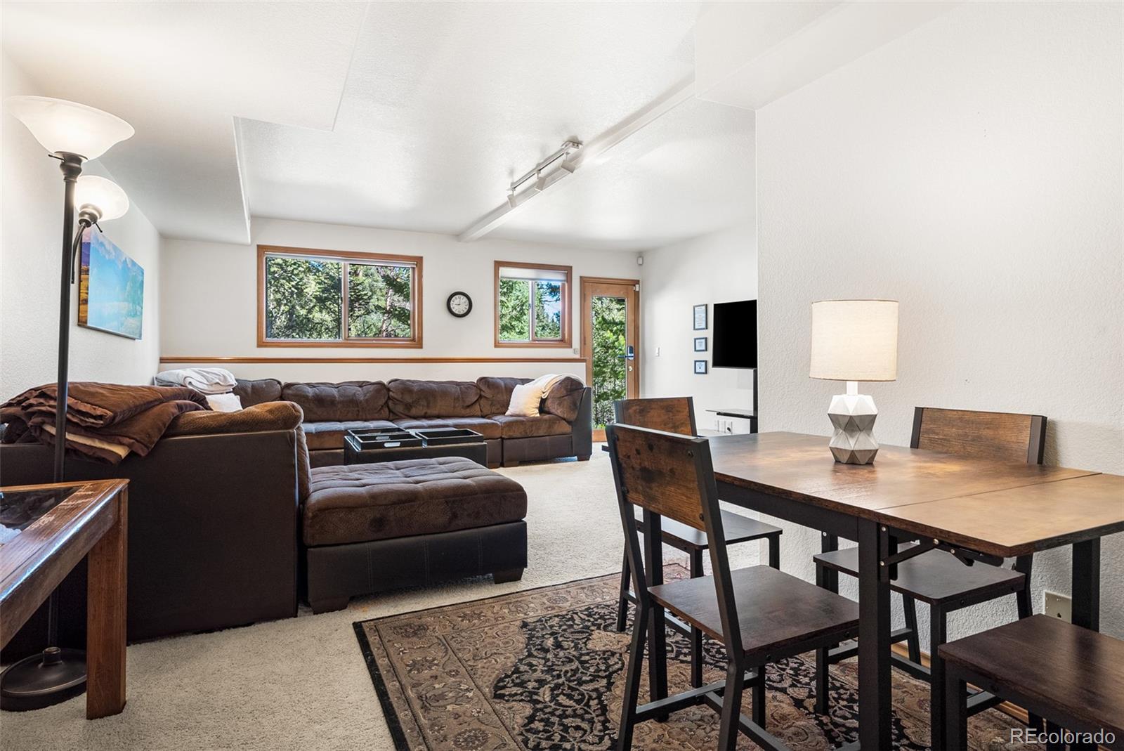 6252 King Drive Evergreen, CO 80439 - Photo 27 of 50 a living room with furniture and a flat screen tv