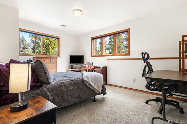 a bedroom with furniture and a window