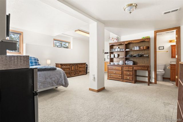a bedroom with furniture and a book shelf
