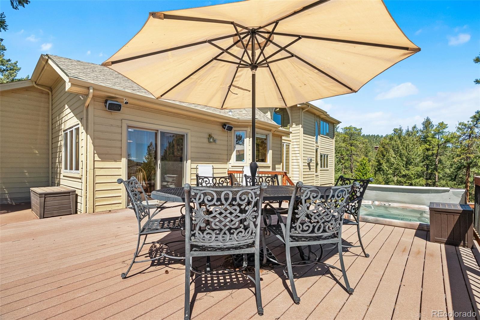 6252 King Drive Evergreen, CO 80439 - Photo 36 of 50 a patio with a patio table and chairs