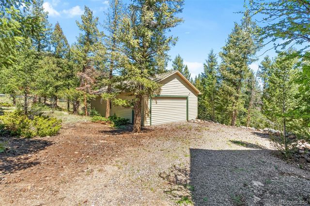 a view of a house with a yard and garage