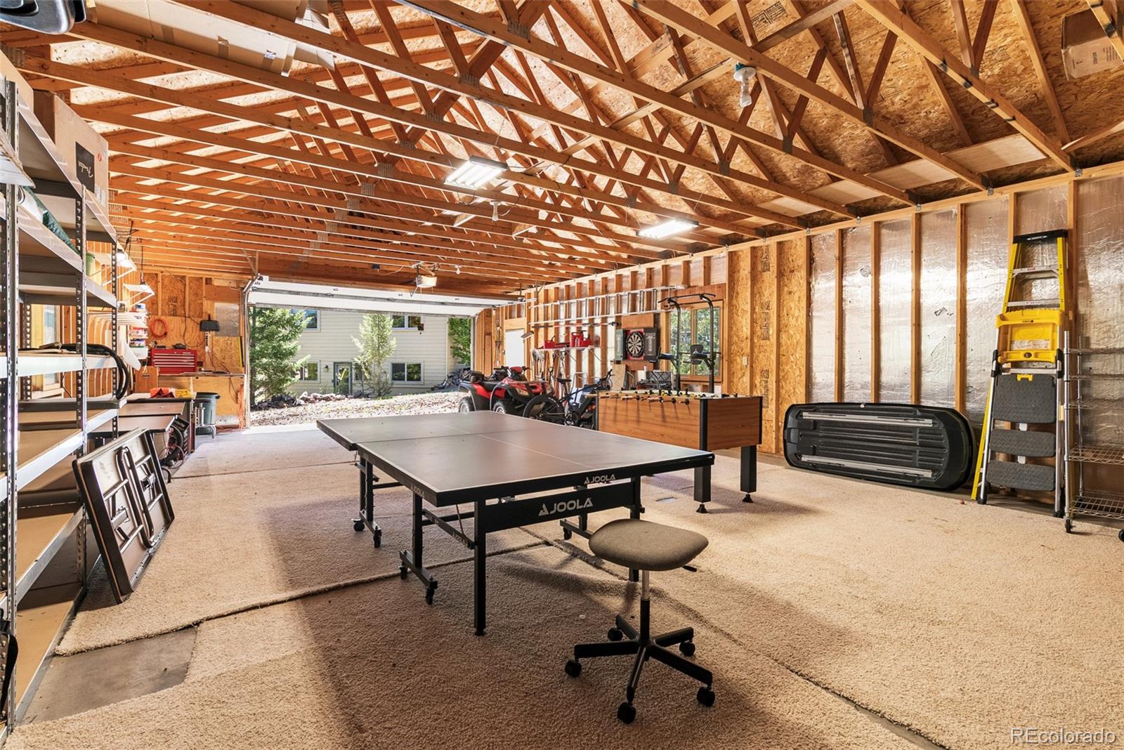 6252 King Drive Evergreen, CO 80439 - Photo 44 of 50 a roof deck with table and chairs with wooden floor and fence