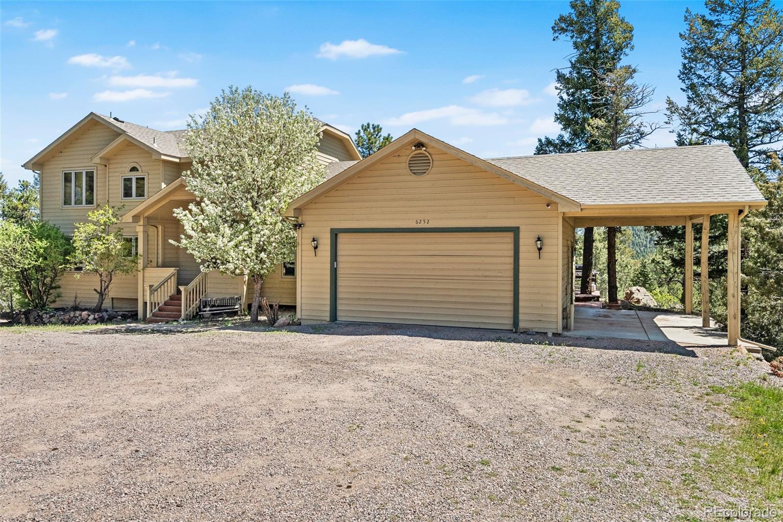 6252 King Drive Evergreen, CO 80439 - Photo 45 of 50 a front view of a house with a yard and garage