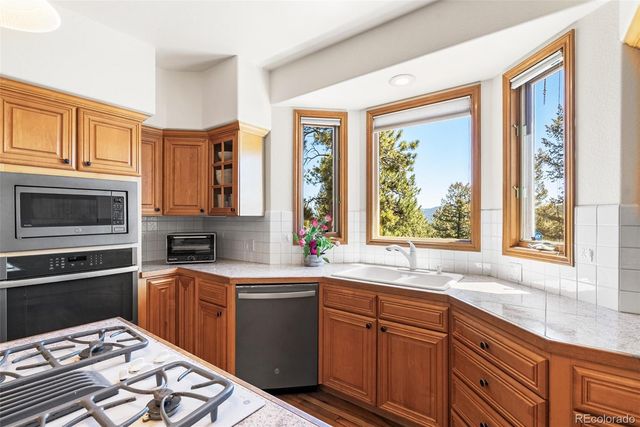 a kitchen with a sink stove and microwave