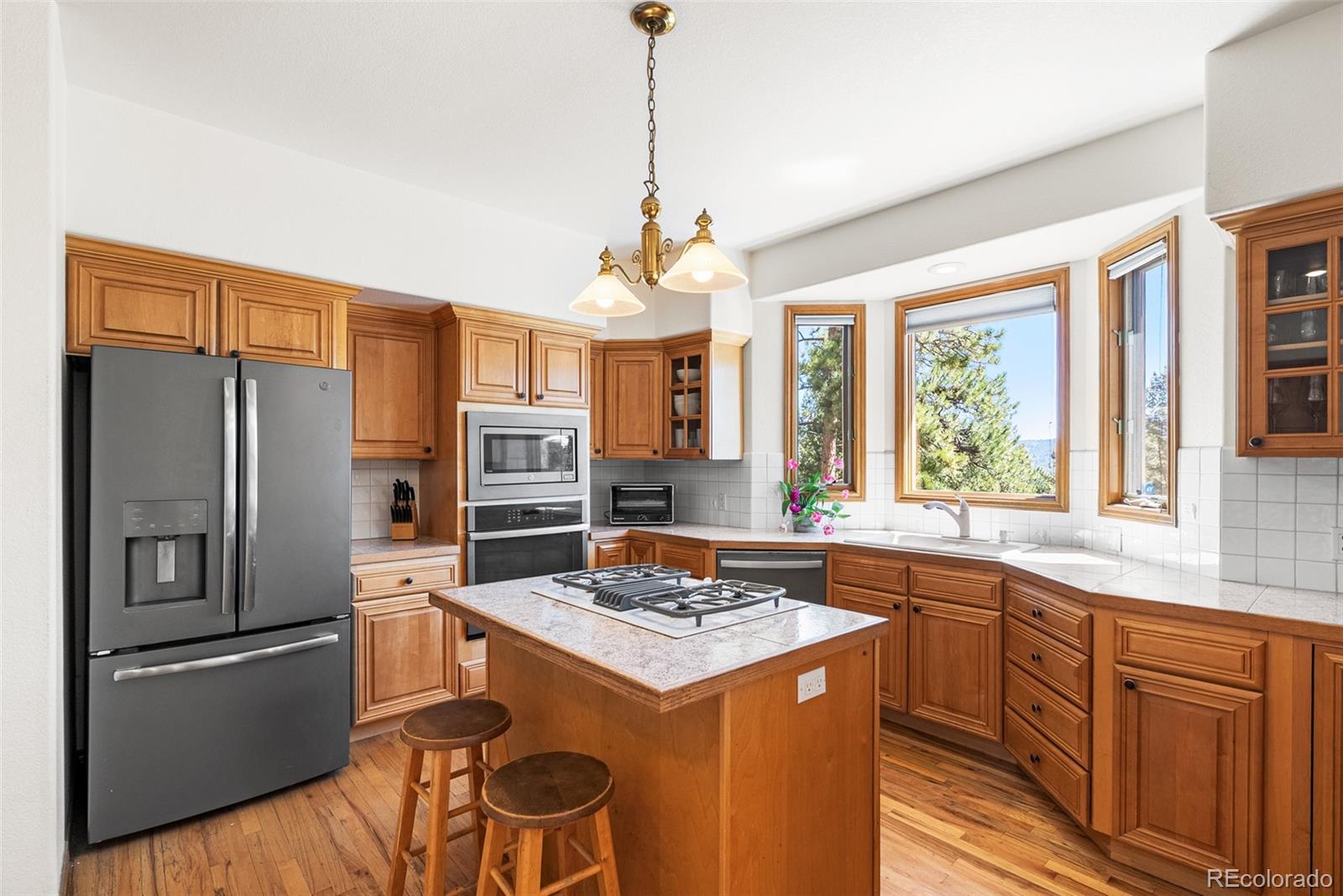 6252 King Drive Evergreen, CO 80439 - Photo 10 of 50 a kitchen that has a stove a sink and a refrigerator
