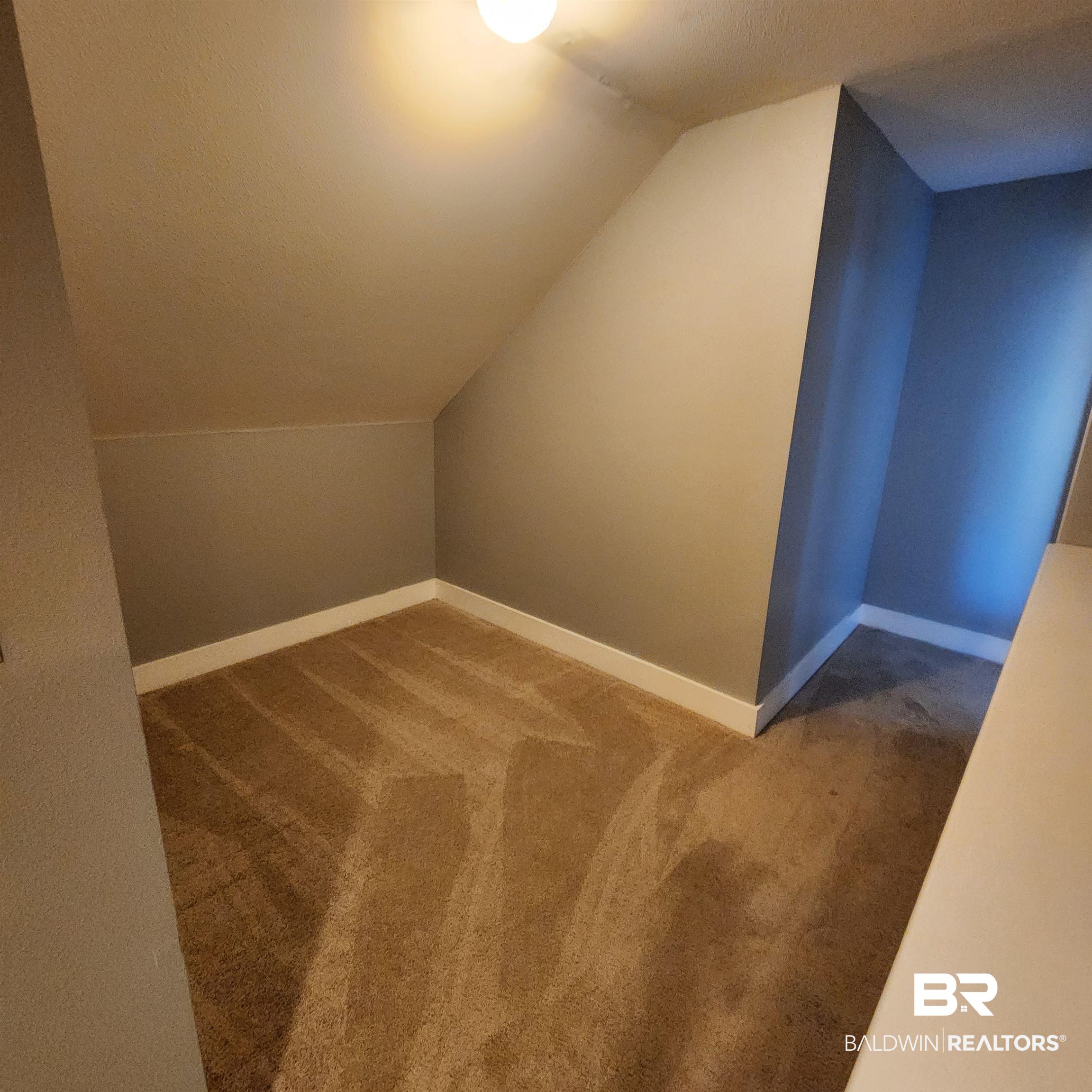 16093 Beasley Road Foley, AL 36535 - Photo 21 of 31 Additional living space featuring a textured ceiling, carpet, and lofted ceiling