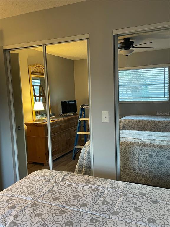 14531 Walsingham Road, Unit 203 Largo, FL 33774 - Photo 17 of 24 a bedroom with a bed and a dresser