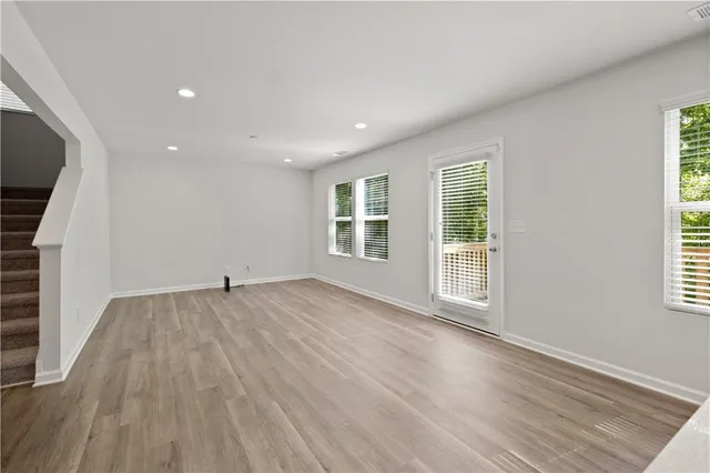 a kitchen with a sink a microwave a refrigerator and cabinets