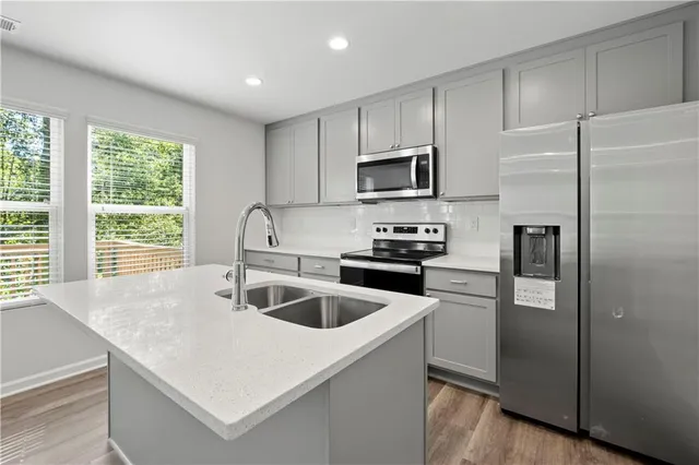 a kitchen with a sink and cabinets