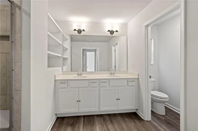 a bathroom with a shower sink and mirror