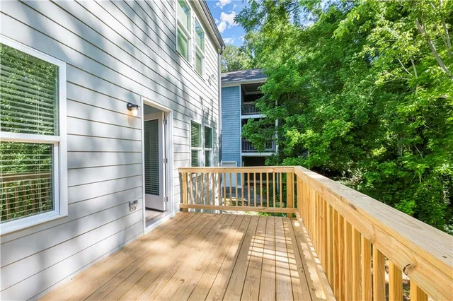 a view of balcony with wooden floor and fence