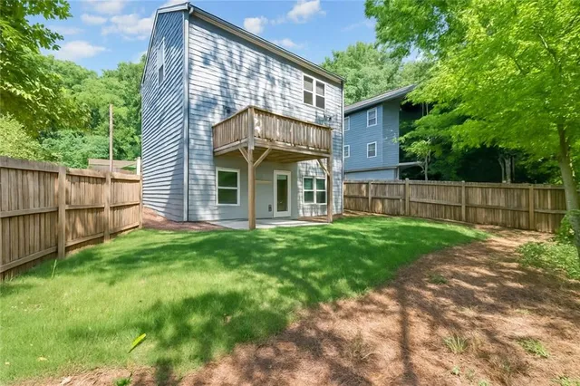 a view of a backyard with a small cabin and wooden fence